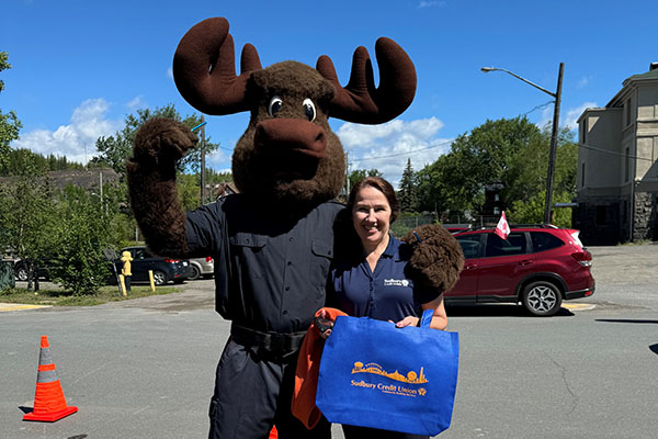 SCU staff member hands out prizes at a community event.