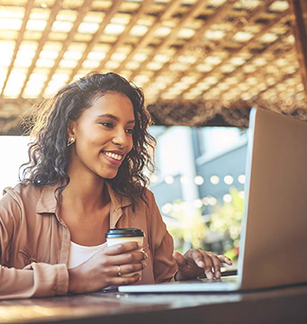 Woman using a laptop at a coffee shop.